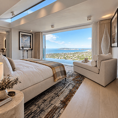Bedroom with floor-to-ceiling windows over Plettenberg Bay